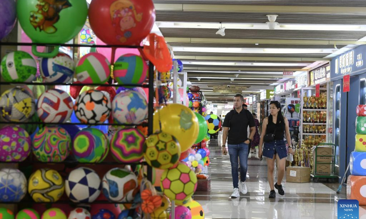 Foreign clients purchase sports goods at Yiwu International Trade City in Yiwu, east China's Zhejiang Province, Sept. 15, 2025. China's Yiwu, dubbed the world's supermarket, has recently witnessed a surge in orders for sports products, driven by major sporting events including the upcoming 2026 FIFA World Cup. (Photo by Shi Kuanbing/Xinhua)