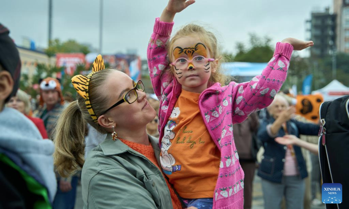 A girl dances during the Tiger Day event in Vladivostok, Russia, Sept. 28, 2025. Since 2000, Vladivostok has celebrated Tiger Day in the last weekend of September each year to raise public awareness about tiger conservation. (Photo by Guo Feizhou/Xinhua)