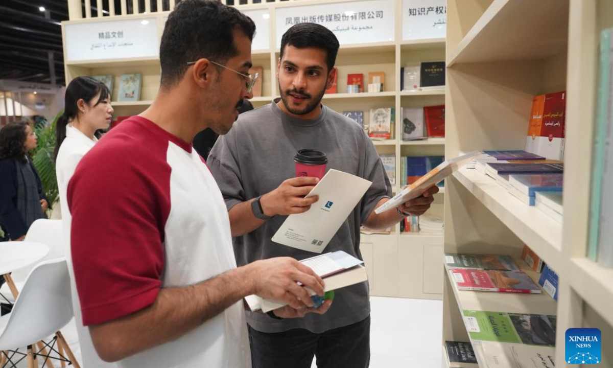 Two men talk at the China Pavilion of the Riyadh International Book Fair 2025 in Riyadh, Saudi Arabia, Oct. 2, 2025. The book fair opened here on Thursday, bringing together over 2,000 local and international publishing houses from more than 25 countries, along with a range of cultural institutions. (Xinhua/Luo Chen)