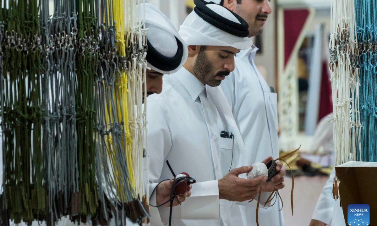 People visit a hunting accessories stall during the S'hail Katara International Hunting and Falcons Exhibition 2025 at Katara Cultural Village in Doha, Qatar, Sept. 10, 2025. The event is held here from Sept. 10 to 14. (Photo by Nikku/Xinhua)