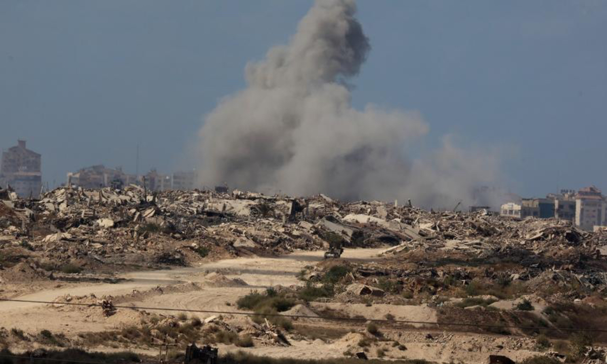 This photo taken on Sept. 30, 2025 shows smoke rising following an attack in Gaza City as seen from Israel. (Photo by Gil Cohen Magen/Xinhua)