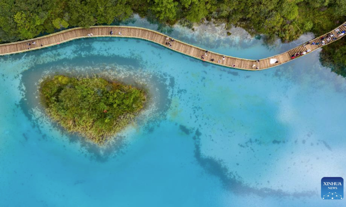 An aerial drone photo taken on Sept. 8, 2025 shows tourists visiting the Lanyue (Blue Moon) Valley in Lijiang City, southwest China's Yunnan Province. (Xinhua/Hu Chao)