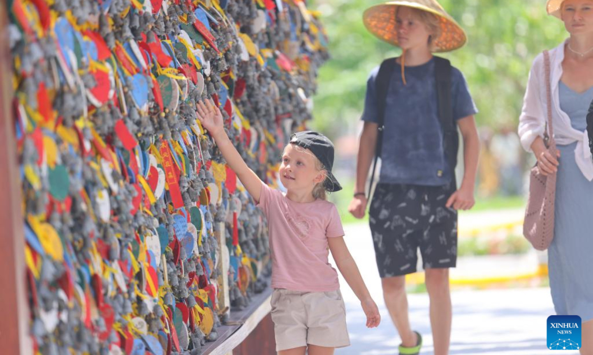 Tourists visit the Nanshan Cultural Tourism Zone in Sanya, south China's Hainan Province, Oct. 7, 2025. Tourists across the country show no sign of fading enthusiasm as the National Day and Mid-Autumn Festival holiday draws to a close. (Photo by Chen Wenwu/Xinhua)