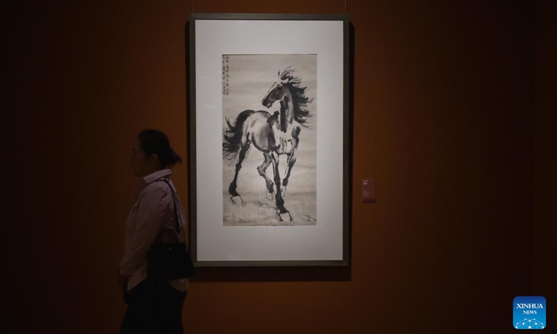 A visitor passes by a painting created by Xu Beihong, a famous Chinese painter, at the National Art Museum of China in Beijing, capital of China, Aug. 25, 2025.(Xinhua/Lu Peng)