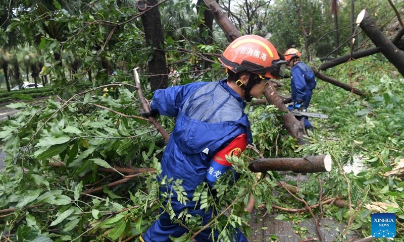 Citizens ride past fallen trees in Sanya, south China's Hainan Province, Aug. 25, 2025. Sanya, a popular tourist destination, wastes no time in getting back to normal after Kajiki, the 13th typhoon of this year, had ploughed through the city. (Xinhua/Zhao Yingquan)