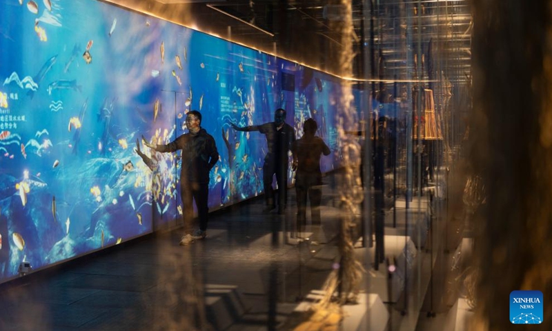 People visit a center for promotion of Hezhe intangible cultural heritages at a folk custom-themed scenic area in Sipai Hezhe Ethnic Township, Raohe County, northeast China's Heilongjiang Province, Aug. 22, 2025. 