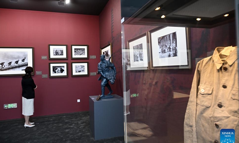 A visitor views exhibits at an art exhibition highlighting the Chinese People's War of Resistance Against Japanese Aggression in Beijing, capital of China, Aug. 26, 2025. (Xinhua/Jin Liangkuai)