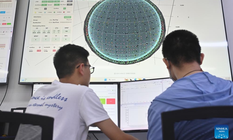 Researchers work at a control room of the Jiangmen Underground Neutrino Observatory (JUNO) in Jiangmen, south China's Guangdong Province, Aug. 26, 2025. The world's largest transparent spherical detector began operation in China on Tuesday, making it the world's first operational ultra-large scientific facility dedicated to neutrino research with ultra-high precision. Having completed the filling of its 20,000-tonne liquid scintillator detector, JUNO in Guangdong began taking data after more than a decade of preparation and construction. (Photo by Liu Yuexiang/Xinhua)