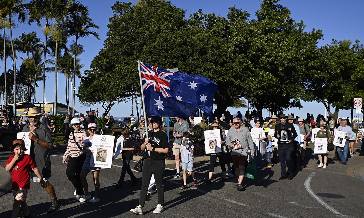 Relatives of World War II veterans march along the Strand as part of the Parade of Veterans on August 16, 2025 in Townsville, Australia. Photo: AFP