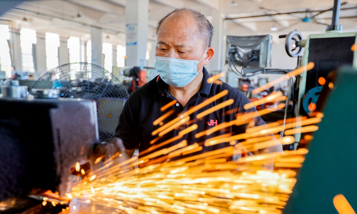 A worker is busy filling orders at a new-energy vehicle (NEV) parts manufacturing company in Ji'an, East China's Jiangxi Province, on August 27, 2025. Businesses in the city are ramping up production and racing to meet booming orders, striving to achieve their annual targets. Official data showed that from January to July 2025, the added value of high-tech manufacturing in Jiangxi grew by 12.6 percent, with NEV products surging by 78.4 percent. Photo: VCG