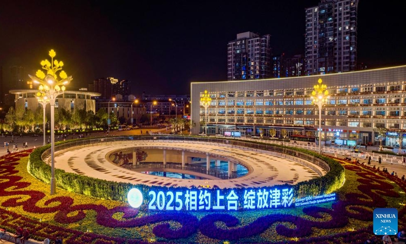 A drone photo taken on Aug. 22, 2025 shows a night scene with a light installation marking the upcoming Shanghai Cooperation Organization (SCO) Summit 2025 on the square behind the Tianjin Railway Station in north China's Tianjin. The SCO Summit 2025 will be held here from Aug. 31 to Sept. 1. (Xinhua/Zhao Zishuo)
