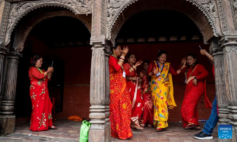 Women celebrate the Teej Festival at the Pashupatinath Temple in Kathmandu, Nepal, Aug. 26, 2025. During the festival, married women fast and pray for good health and longevity of their husbands and unmarried women pray for marrying ideal husbands. (Photo by Hari Maharjan/Xinhua)