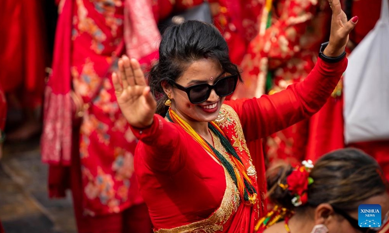 A woman celebrates the Teej Festival at the Pashupatinath Temple in Kathmandu, Nepal, Aug. 26, 2025. During the festival, married women fast and pray for good health and longevity of their husbands and unmarried women pray for marrying ideal husbands. (Photo by Hari Maharjan/Xinhua)