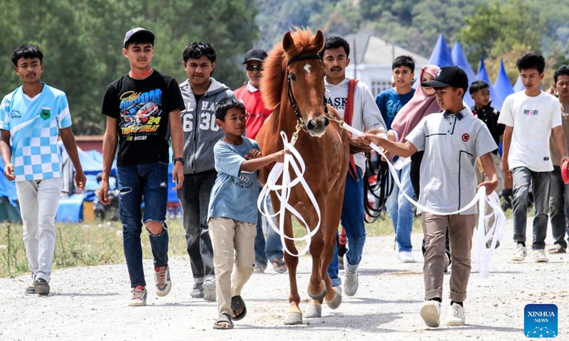 Teenage jockeys prepare before competing in a traditional horse race in Takengon, Aceh Province, Indonesia, Aug. 26, 2025. (Photo by Yulham/Xinhua)