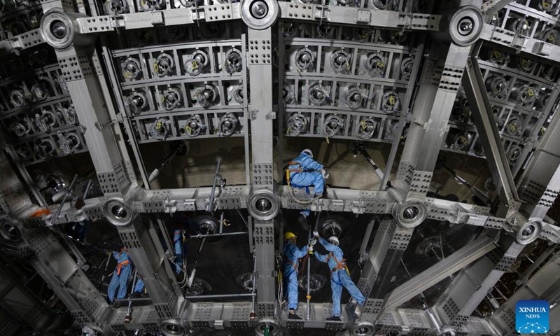 Staff members work on a stainless steel truss of the central detector of the Jiangmen Underground Neutrino Observatory (JUNO) in Jiangmen, south China's Guangdong Province, Oct. 10, 2024.(Xinhua/Jin Liwang)