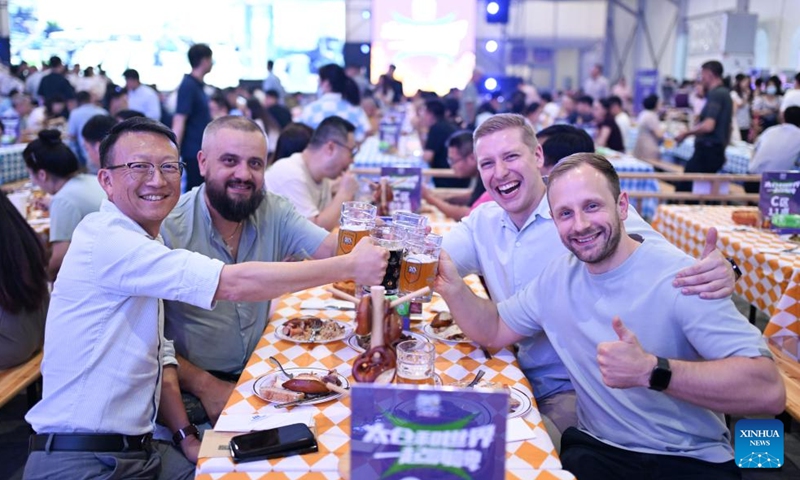People pose for photos at the 20th Taicang Rothenburg beer festival in Taicang City, east China's Jiangsu Province, Aug. 26, 2025.The festival kicked off here on Tuesday. (Photo by Wang Xuzhong/Xinhua)