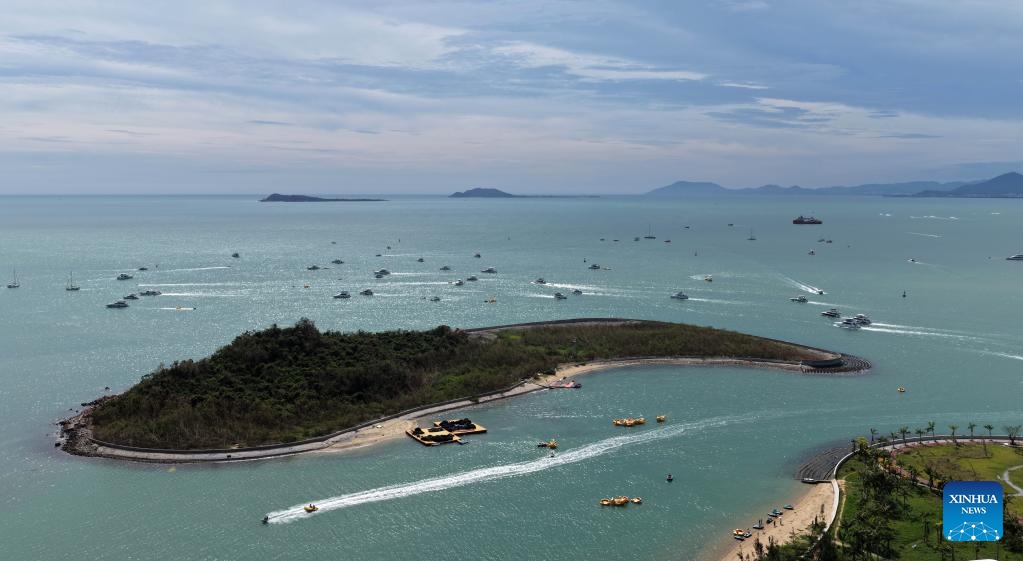 An aerial drone photo taken on Aug. 27, 2025 shows tourists going on a yacht trip for sightseeing in Sanya, south China's Hainan Province. After Typhoon Kajiki swept through, Sanya City has been moving swiftly to restore its tourism market. (Xinhua/Zhao Yingquan)