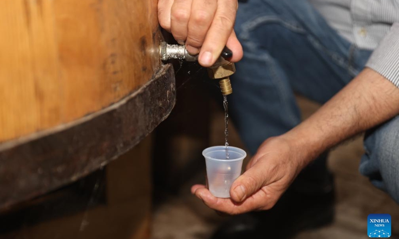 A man checks the quality of mezcal in a mezcal production facility in Teul de Gonzalez Ortega, State of Zacatecas, Mexico, Aug. 26, 2025. In Teul de Gonzalez Ortega, a town in southern Zacatecas, agave is an important crop. Mezcal is produced by roasting agave cores, extracting the juice, fermenting, and distilling, with some batches further aged in wooden barrels. This craft not only preserves ancient traditions but also supports local economic growth. (Xinhua/Li Mengxin)