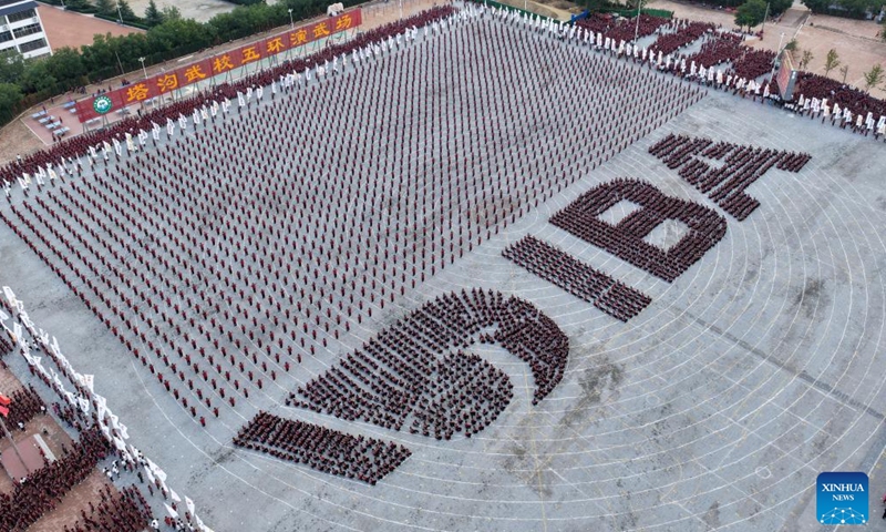 A drone photo taken on Aug. 27, 2025 shows students of Shaolin Tagou Martial Arts School forming a human IBA logo during the celebration of the International Boxing Day held by the International Boxing Association (IBA) in Dengfeng, Zhengzhou, central China's Henan Province. (Xinhua/Li Jianan)