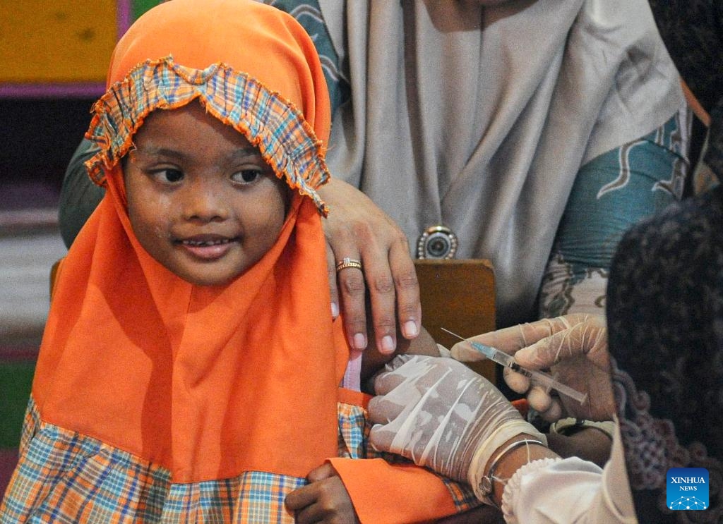 A girl smiles before receiving a dose of measles vaccine in Sumenep Regency, East Java, Indonesia, on Aug. 27, 2025. Indonesia has recorded 46 measles cases across 42 districts and cities in 13 provinces, with Sumenep in East Java identified as the worst-affected area with 17 deaths, the Ministry of Health said on Tuesday. (Photo by Sahlan Kurniawan/Xinhua)