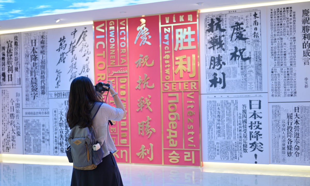 A visitor takes photo of a wall display at the Zhejiang Provincial Archives. Photos on this page: VCG