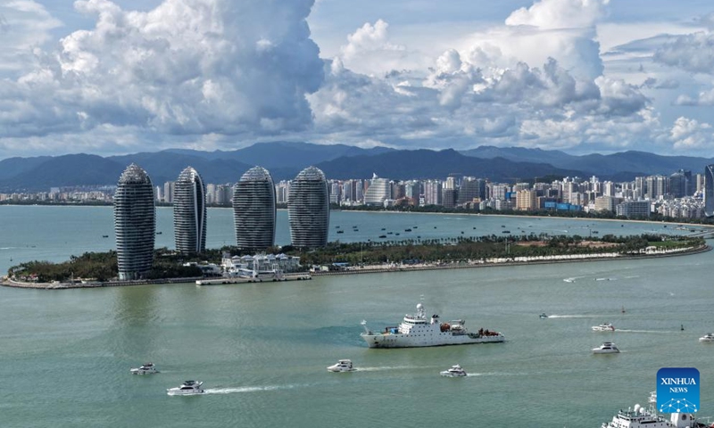 An aerial drone photo taken on Aug. 27, 2025 shows tourists going on a yacht trip for sightseeing in Sanya, south China's Hainan Province. After Typhoon Kajiki swept through, Sanya City has been moving swiftly to restore its tourism market. (Xinhua/Zhao Yingquan)