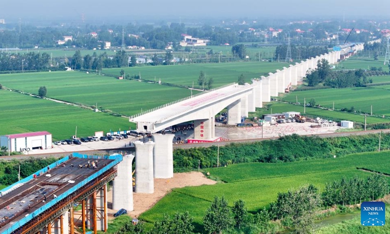 An aerial drone photo taken on Aug. 28, 2025 shows the T-beam of the Shuhe River super major bridge along the Weifang-Suqian high-speed railway rotating to its desired position in Tancheng of Linyi City, north China's Shandong Province. The T-beam successfully rotated to its desired position on Thursday. The Weifang-Suqian high-speed railway crosses over the Jiaozhou-Xinyi railway by the Shuhe River super major bridge, which is now under construction here. Photo: Xinhua