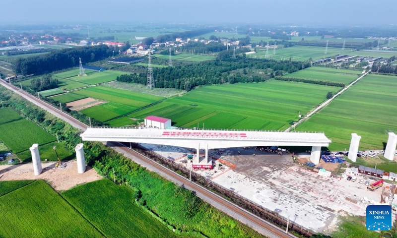 An aerial drone photo taken on Aug. 28, 2025 shows the T-beam of the Shuhe River super major bridge along the Weifang-Suqian high-speed railway rotating to its desired position in Tancheng of Linyi City, north China's Shandong Province. The T-beam successfully rotated to its desired position on Thursday. The Weifang-Suqian high-speed railway crosses over the Jiaozhou-Xinyi railway by the Shuhe River super major bridge, which is now under construction here. Photo: Xinhua