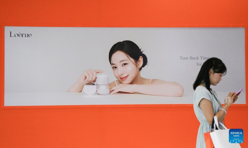 A visitor walks by a billboard at the Seoul Beauty Week event in Seoul, South Korea, Aug. 28, 2025. The three-day Beauty Week event kicked off in Seoul on Thursday, attracting numerous cosmetics brands and professionals to attend. Photo: Xinhua
