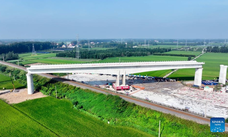 An aerial drone photo taken on Aug. 28, 2025 shows the T-beam of the Shuhe River super major bridge along the Weifang-Suqian high-speed railway rotating to its desired position in Tancheng of Linyi City, north China's Shandong Province. The T-beam successfully rotated to its desired position on Thursday. The Weifang-Suqian high-speed railway crosses over the Jiaozhou-Xinyi railway by the Shuhe River super major bridge, which is now under construction here. Photo: Xinhua