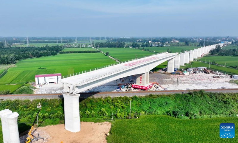An aerial drone photo taken on Aug. 28, 2025 shows the T-beam of the Shuhe River super major bridge along the Weifang-Suqian high-speed railway rotating to its desired position in Tancheng of Linyi City, north China's Shandong Province. The T-beam successfully rotated to its desired position on Thursday. The Weifang-Suqian high-speed railway crosses over the Jiaozhou-Xinyi railway by the Shuhe River super major bridge, which is now under construction here. Photo: Xinhua