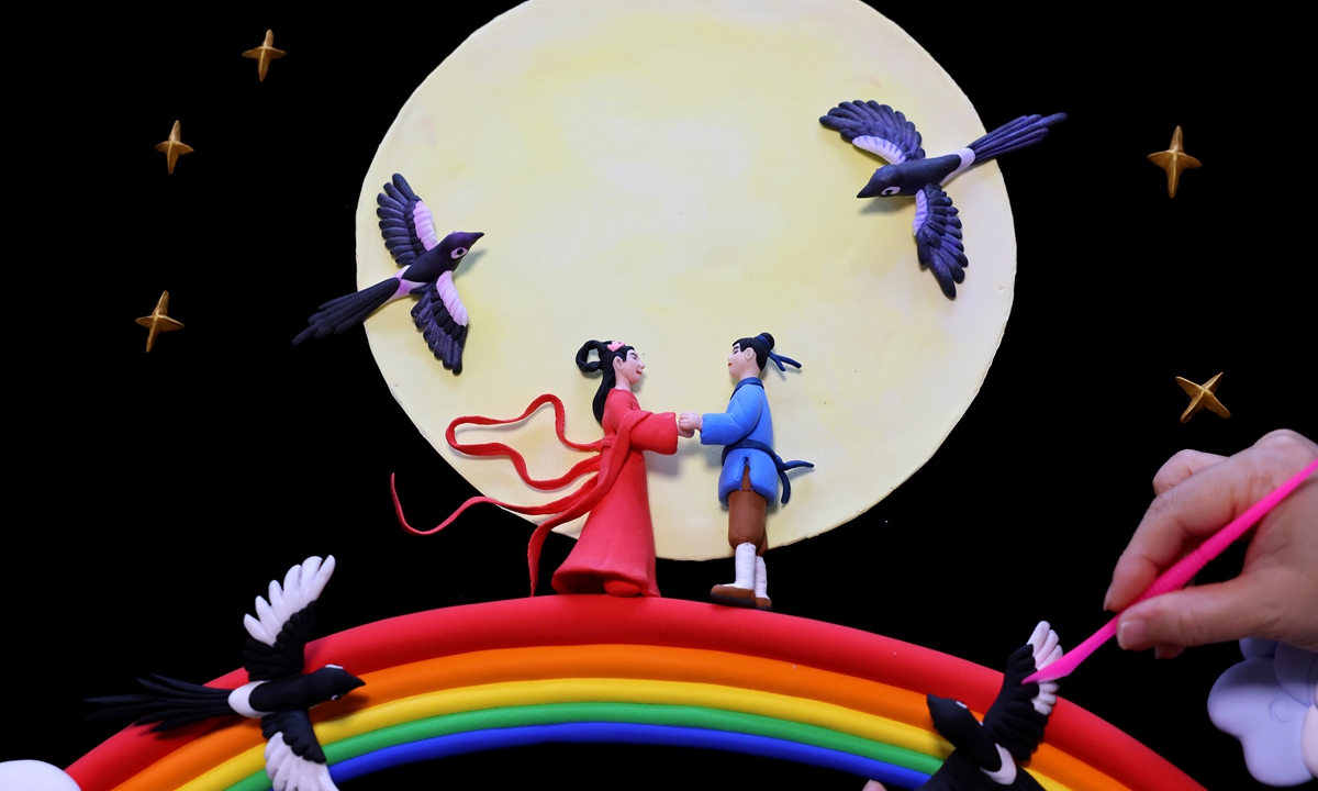 A folk artist creates a dough sculpture depicting the ancient tale of the Cowherd and the Weaver Girl, the love story behind the Qixi Festival, also known as Chinese Valentine's Day, at the intangible cultural heritage protection center in Zaozhuang, East China's Shandong Province, on August 29, 2025. Photo: VCG