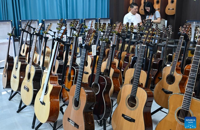 Visitors view the guitar products at a guitar company in Songzi, central China's Hubei Province, Aug. 28, 2025. The guitar making industry has become the city's signature industry. (Xinhua/Du Zixuan)