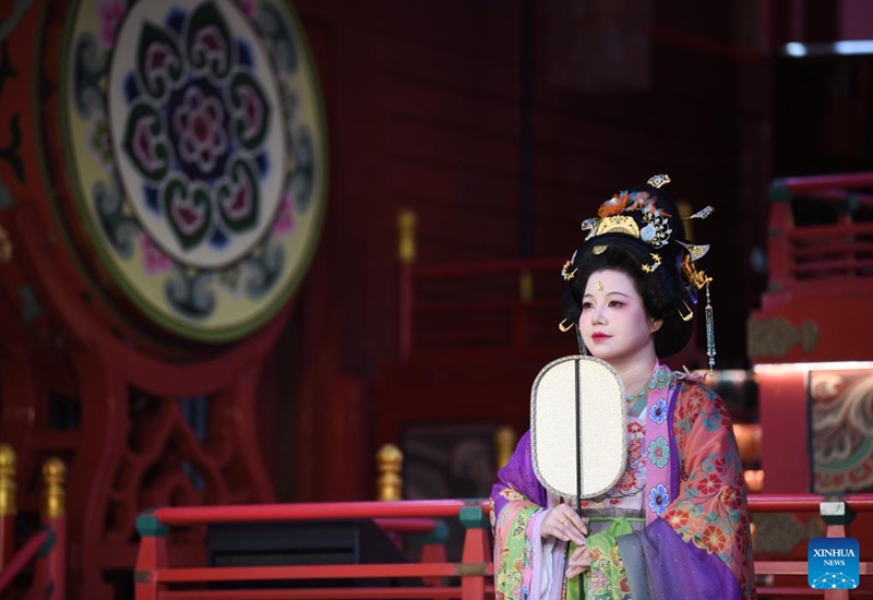 An actress performs to display traditional costumes at a theme block in Xi'an, northwest China's Shaanxi Province, Aug. 29, 2025. (Xinhua/Zhang Bowen)