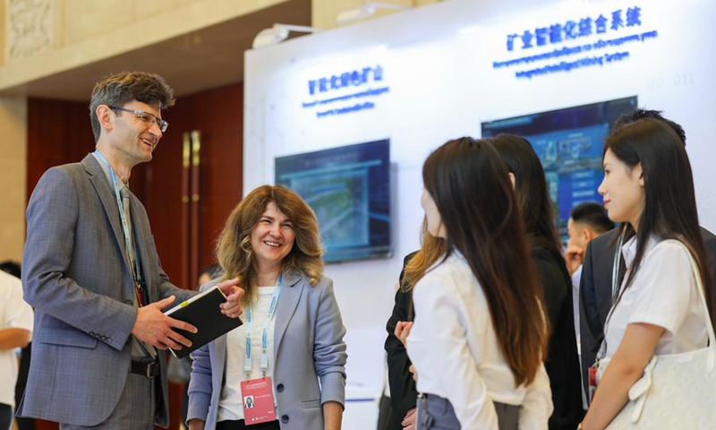 Guests and exhibitors communicate at the interactive experience zone during the 2025 Shanghai Cooperation Organization (SCO) Digital Economy Forum in north China's Tianjin, July 11, 2025. (Xinhua/Sun Fanyue)
