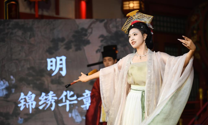 An actress performs to display traditional costumes at a theme block in Xi'an, northwest China's Shaanxi Province, Aug. 29, 2025. (Xinhua/Zhang Bowen)