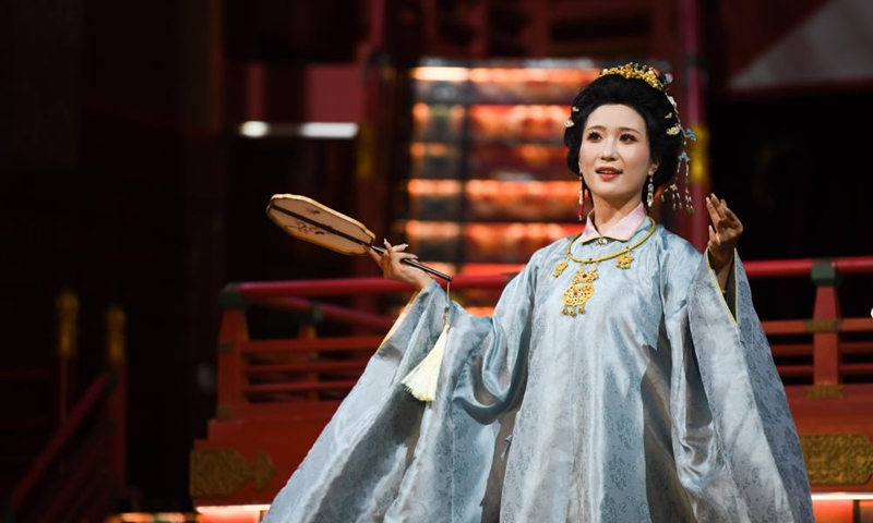 An actress performs to display traditional costumes at a theme block in Xi'an, northwest China's Shaanxi Province, Aug. 29, 2025. (Xinhua/Zhang Bowen)