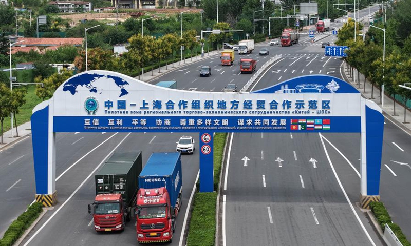 An aerial drone photo taken on Aug. 27, 2025 shows trucks transporting cargo on a road in the China-SCO (the Shanghai Cooperation Organization) Local Economic and Trade Cooperation Demonstration Area (SCODA) in Qingdao, east China's Shandong Province. (Xinhua/Li Ziheng)
