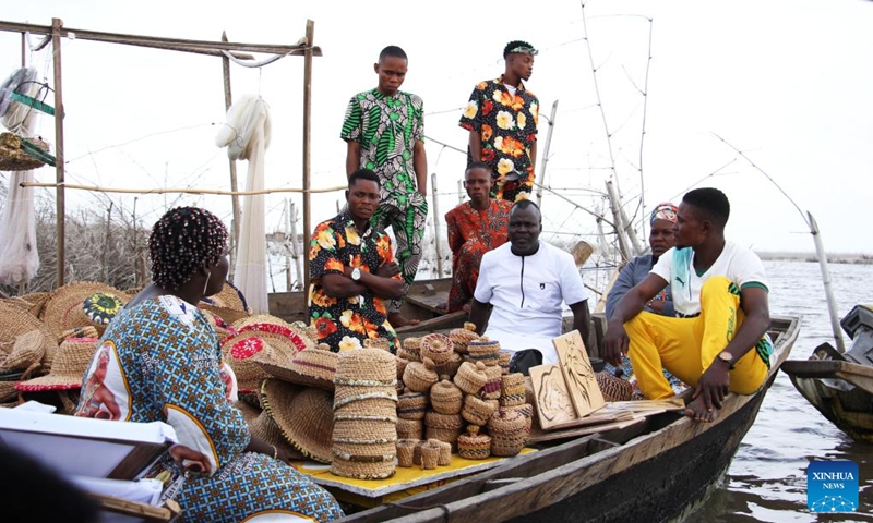 People show handicrafts on a canoe during a festival of water sports, culture and arts in Ganvie, near Cotonou, Benin, Aug. 30, 2025. (Photo: Xinhua)