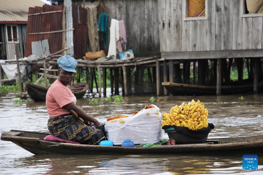 A vendor sells fruits during a festival of water sports, culture and arts in Ganvie, near Cotonou, Benin, Aug. 30, 2025. (Photo: Xinhua)