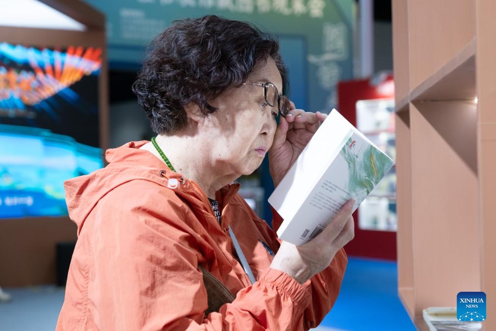 A reader views a book at a book fair in Hohhot, north China's Inner Mongolia Autonomous Region, Aug. 31, 2025. The five-day book fair, which gathered over 300 publishers nationwide, concluded here on Sunday. (Photo: Xinhua)