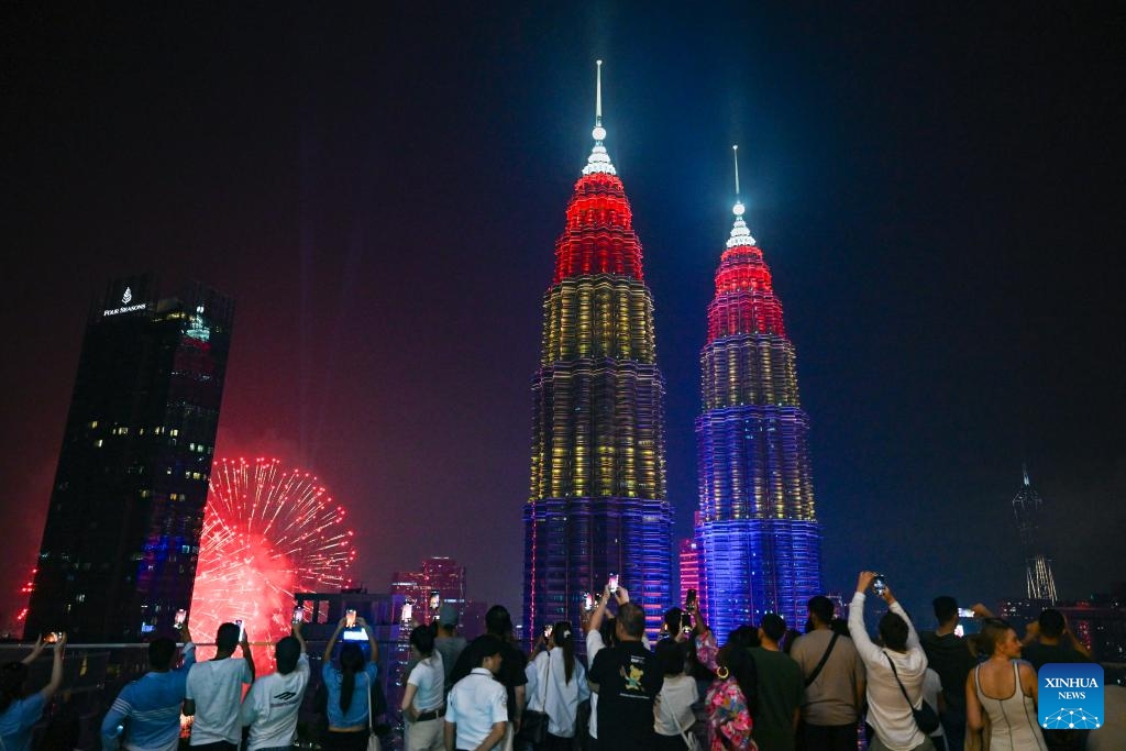 People take photos of fireworks in celebration of Malaysia's 68th anniversary of independence near the Petronas Twin Towers in Kuala Lumpur, Malaysia, Aug. 31, 2025. Malaysia celebrated its 68th anniversary of independence on Sunday. (Photo: Xinhua)