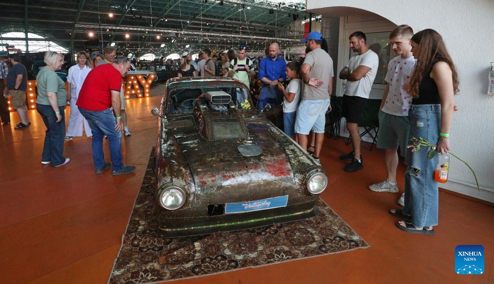 Visitors view cars at a vintage car exhibition in Minsk, Belarus, Aug. 30, 2025. The exhibition opened here on Saturday, showcasing more than 400 restored vehicles. (Photo: Xinhua)