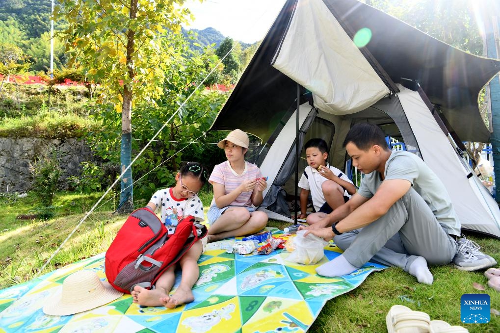 People enjoy the pleasure of camping at a forest farm in Tongcheng County of Xianning City, central China's Hubei Province, Aug. 29, 2025. (Photo: Xinhua)