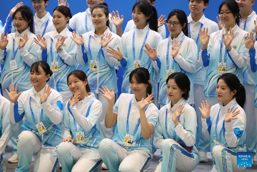 Volunteers pose for a group photo at the media center for the Shanghai Cooperation Organization (SCO) Summit 2025 in north China's Tianjin, on Aug. 29, 2025. The SCO Summit 2025 is held from Aug. 31 to Sept. 1 in Tianjin. A team of nearly 1,000 volunteers from local universities provide various service in areas like diplomatic etiquette, emergency response and language services to support the SCO Summit. (Photo: Xinhua)