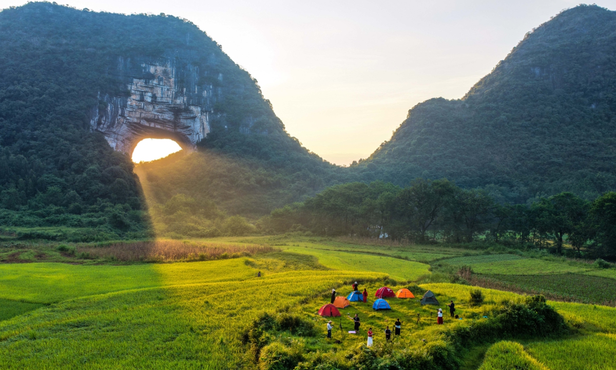 Tourists visit the Yueyan Scenic Area in Daoxiao, Central China's Hunan Province, on September 2, 2025. The hole in the rock, or tiankeng (lit: skypit), in this scenic area, known for its typical karst landscape and the Tyndall effect created by sunlight passing through the cave, attracts tourists and photography enthusiasts to visit and capture stunning shots. Photo: VCG