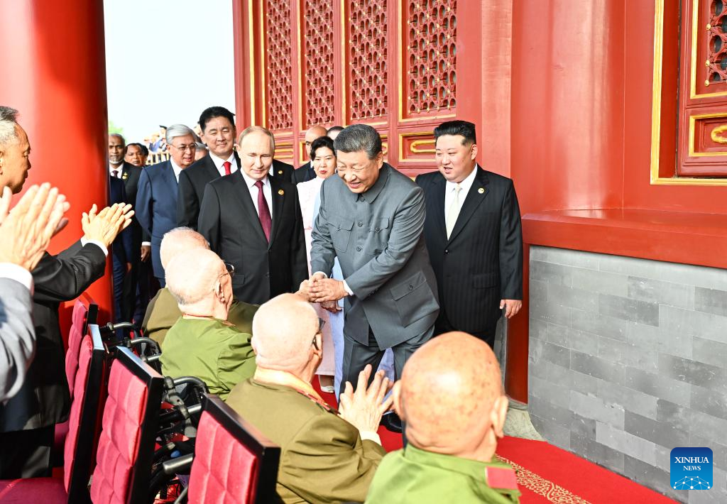 Chinese President Xi Jinping, also general secretary of the Communist Party of China Central Committee and chairman of the Central Military Commission, shakes hands with war veterans at Tian'anmen Rostrum in Beijing, capital of China, Sept. 3, 2025. China on Wednesday held a grand gathering to commemorate the 80th anniversary of the victory in the Chinese People's War of Resistance against Japanese Aggression and the World Anti-Fascist War. (Xinhua/Yan Yan)