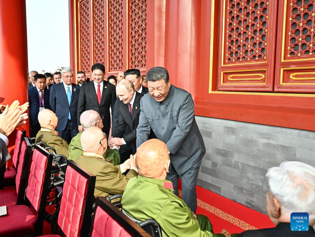 Chinese President Xi Jinping, also general secretary of the Communist Party of China Central Committee and chairman of the Central Military Commission, shakes hands with war veterans at Tian'anmen Rostrum in Beijing, capital of China, Sept. 3, 2025. China on Wednesday held a grand gathering to commemorate the 80th anniversary of the victory in the Chinese People's War of Resistance against Japanese Aggression and the World Anti-Fascist War. (Xinhua/Yan Yan)