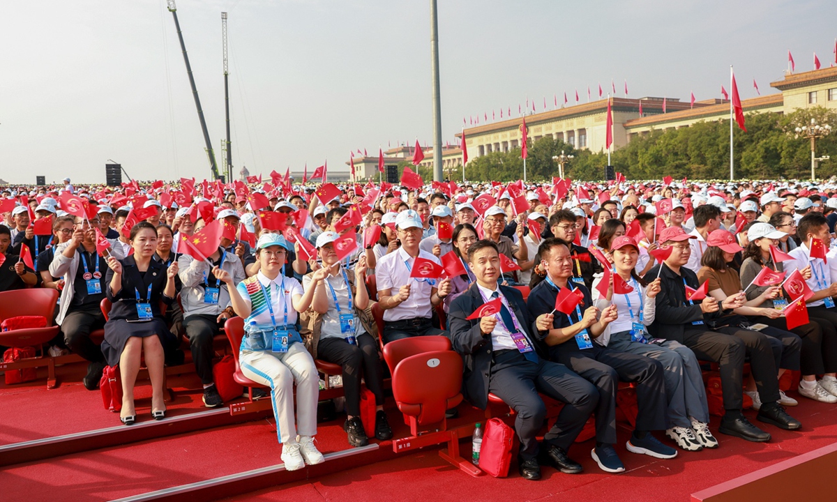 China holds a massive military parade in Beijing on September 3, 2025 to mark the 80th anniversary of its victory in World War II. People attending the event wave flags. Photo: VCG 