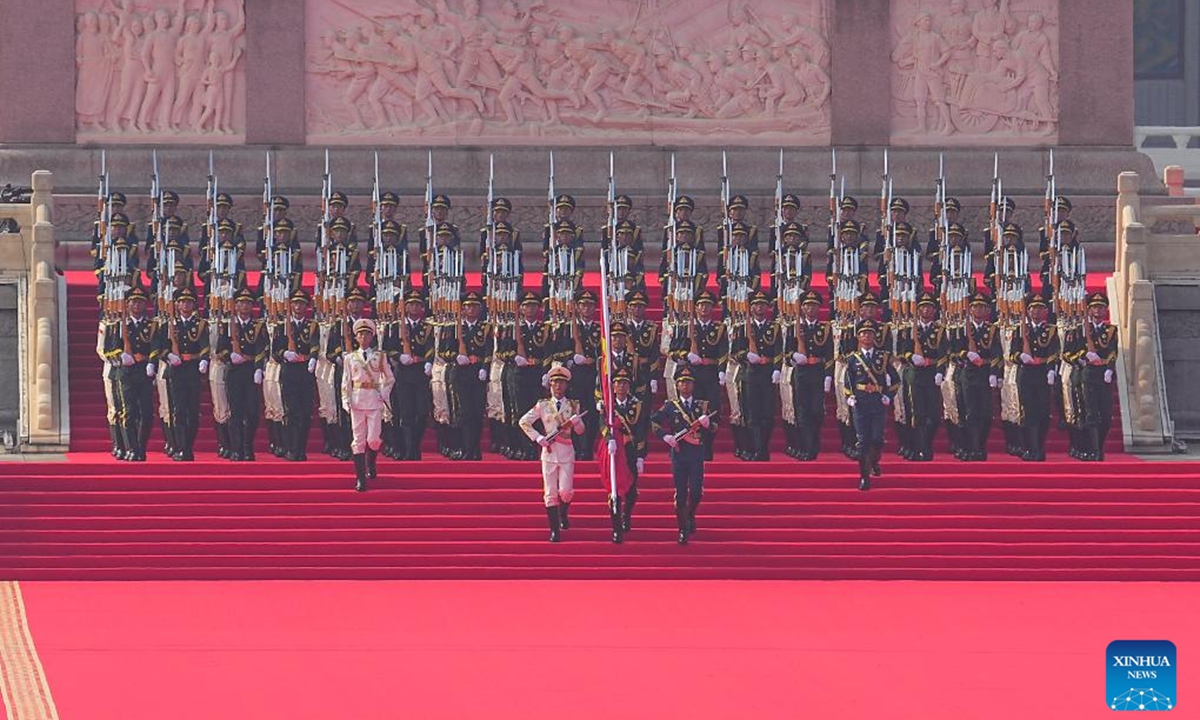 Soldiers escort the Chinese national flag for a flag-raising ceremony during a grand gathering to commemorate the 80th anniversary of the victory in the Chinese People's War of Resistance against Japanese Aggression and the World Anti-Fascist War in Beijing, capital of China, Sept. 3, 2025. (Xinhua/Xing Guangli)